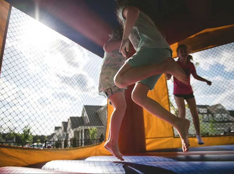 A toddler playing in a bouncy house